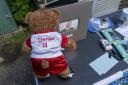 A teddy bear in a football jersey left as a tribute at a vigil at Hainault Underground station car park (Jeff Moore/PA)