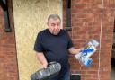 AFTERMATH: Terry Harrison holding the remains of his Hoodrich sandles and PS4 games wrecked by the police chainsaw raid in Canterbury Road in Ronkswood