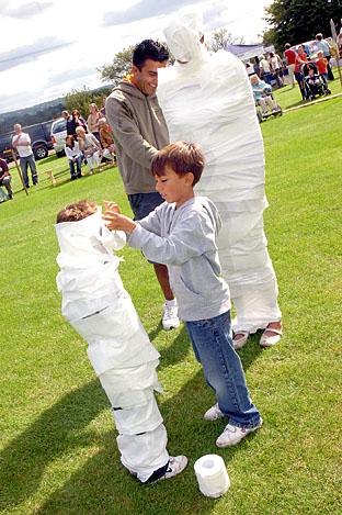 'Dress the Mummy', Connor Mehmet, eight, dressing his brother Reece, five, and their dad Tark Mehmet dressing their mum Lisa Mehmet