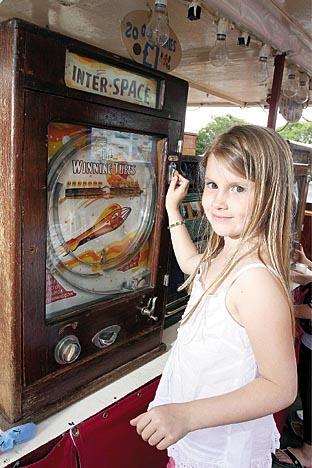 Anya Troughton, 9, plays on the antique fruit machines