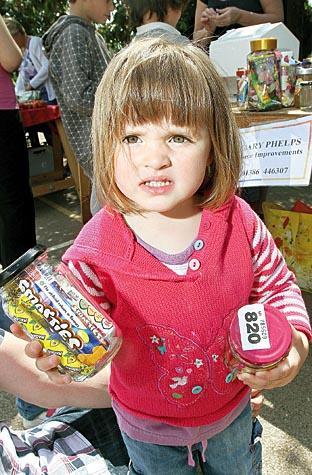 Connie Baker, 2, wins a prize on the tombola stall