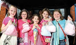 Mia Stanton, seven, Milly Wilson, seven, Abigail Wilson, five, Olivia Radburn, eight and Grace Betts, eight, buy some candyfloss.