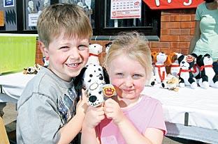 Daniel and Beatrice Yates, aged six and three, win two cuddly toys on the tombola.