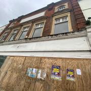 Councillors have agreed to write to the owners of a boarded-up High Street building to ask for them to tidy it up