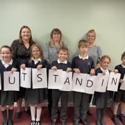 DELIGHT: Staff and pupils at Harvington CE First School in Evesham celebrate their 'outstanding' rating from Ofsted