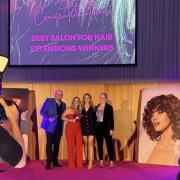 Louise Hickman and Imogen Goodwin, centre, collecting Love Hairs awards on behalf of the salon.