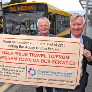 JUST THE TICKET: Councillors Bob Banks and John Smith, cabinet member responsible for highways, advertise the halfprice bus fares.