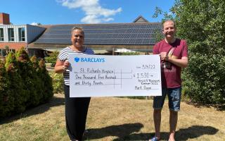 Mark Payne presents Ria Simons, fundraiser, with a cheque for funds raised at the 2022 event.