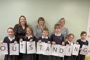 DELIGHT: Staff and pupils at Harvington CE First School in Evesham celebrate their 'outstanding' rating from Ofsted