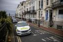 Three people have been bailed after a woman was found dead at a hotel in Brighton