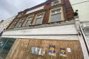 Councillors have agreed to write to the owners of a boarded-up High Street building to ask for them to tidy it up