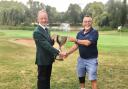Seniors Section captain Brian Bunn presents Ed Mountney with the 2022 Senior Club Championship trophy