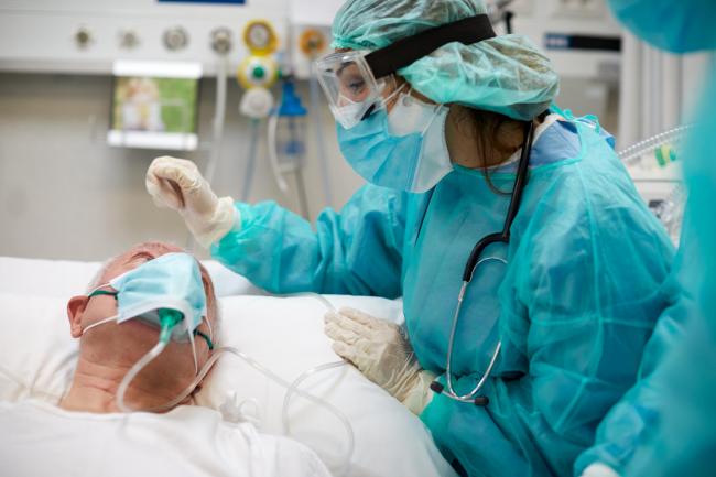 COVID: Nurse comforting a covid patient at the ICU. Picture: Getty Images