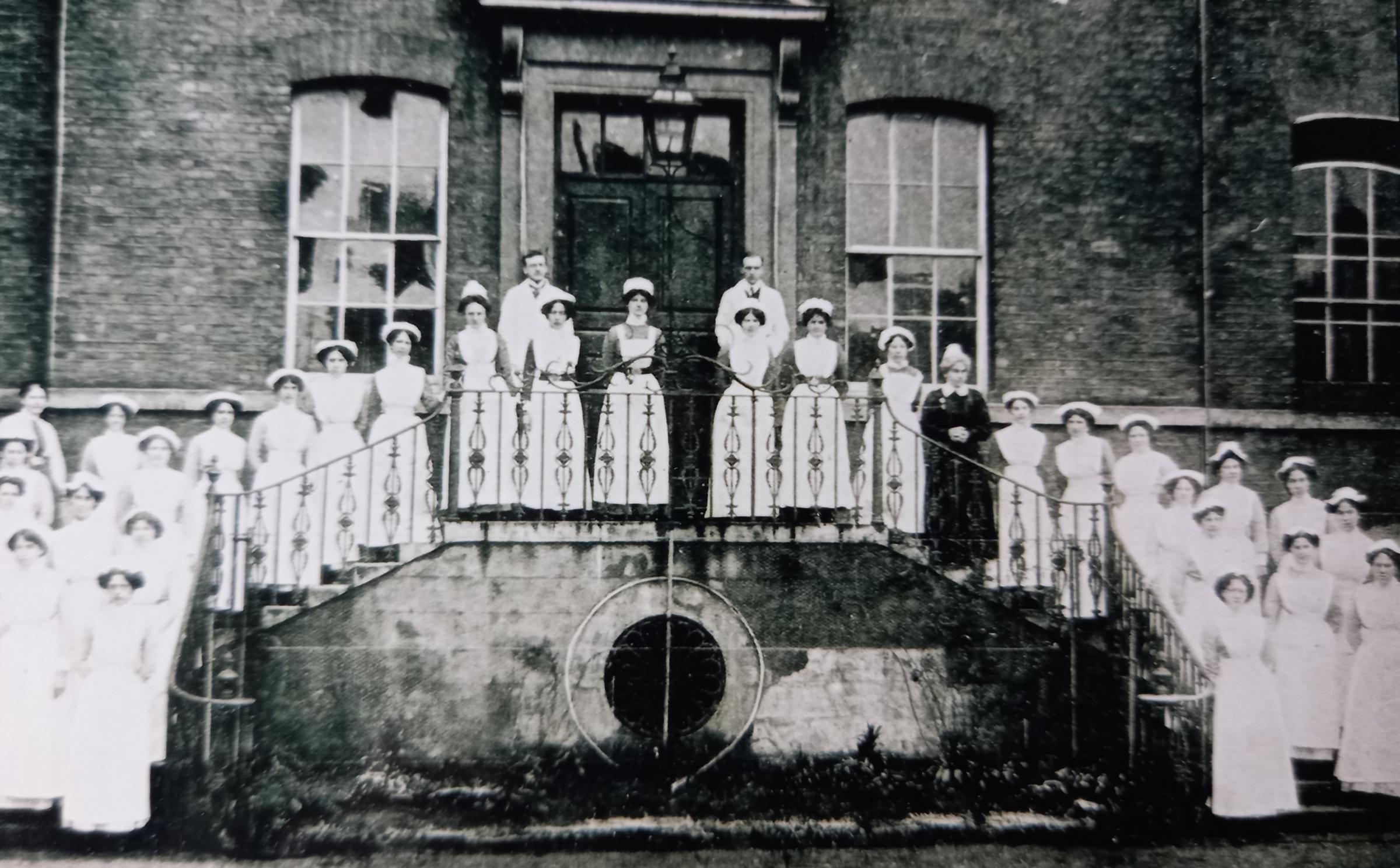Lovely old undated photo of nursing staff on the steps of the hospital entrance off Infirmary Walk