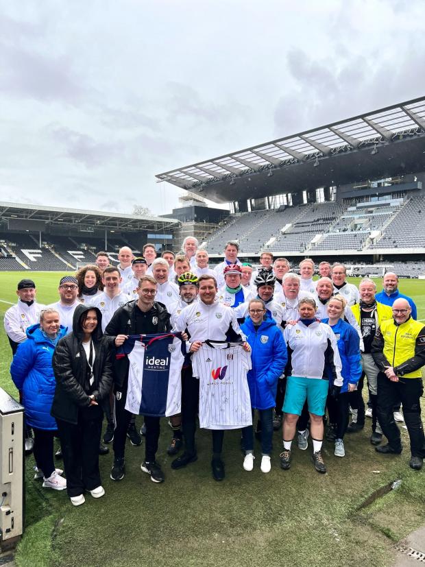 Evesham Journal: The 29-strong team of cyclists at Fulham FC's Craven Cottage in West London