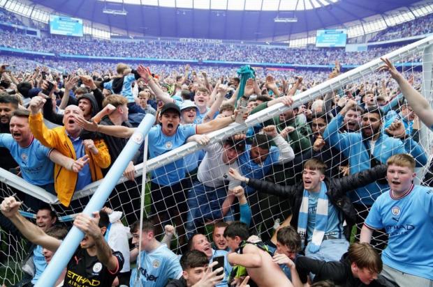 Evesham Journal: INVASION: Manchester City fans invade the pitch after the title win on Sunday. Picture: PA
