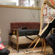 Bianka Van Rooyen, sister to prize-winner Larissa, listens to Dampier’s Round harpist Moira Gutteridge