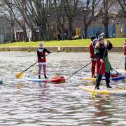 Dozens of paddleboarding Santas took to the river in Evesham at the weekend. Photo: Reg Richardson
