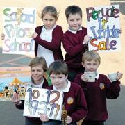 l Pictured promoting the school jumble sale are, back from left: Emma Perry, aged 11 and James Harris, 10. Front from left: Kira Stanley, Sam Orchard, both nine, and Karl Wilkins, eight, promoting Recycle It. 10mar11034-2. Picture by BEN DALBY.