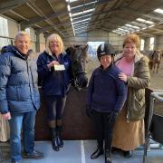 The Edwards family present a cheque to Lesley Gorton, general manager at Cotswold RDA
