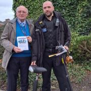 FINES: Councillor Rob Adams and PC Matt Beards with a seized scooter and the educational leaflets