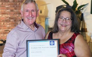 District Governor Jim Currie hands Rotary in the Vale club president Sandra Capaldi the charter certificate